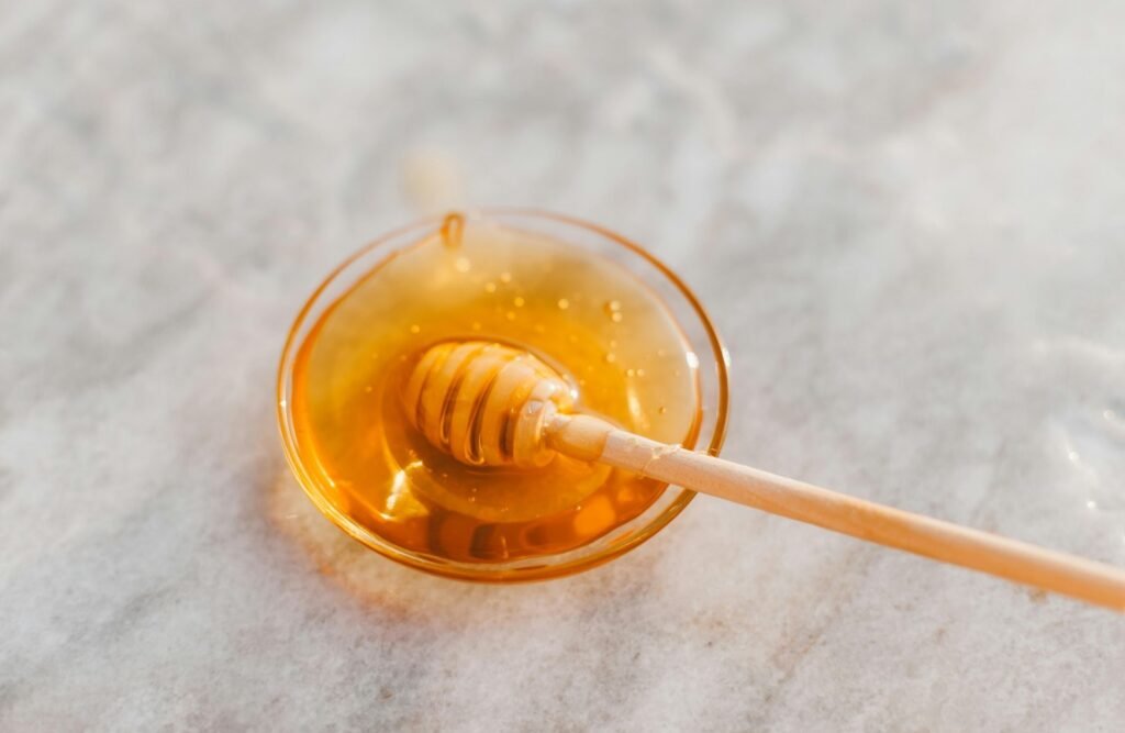 Tea for a sore throat. A dish of fresh honey.